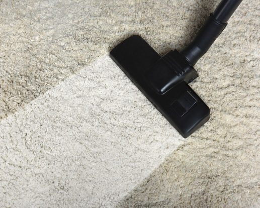 close-up view of cleaning white carpet with professional vacuum cleaner close-up view of cleaning white carpet with professional vacuum cleaner