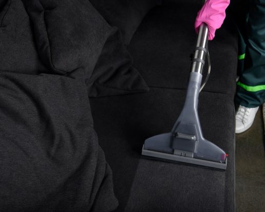 cropped shot of person cleaning furniture with vacuum cleaner, upholstery cleaning concept cropped shot of person cleaning furniture with vacuum cleaner, upholstery cleaning concept