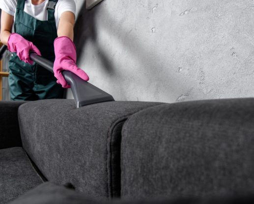 cropped shot of woman in rubber gloves cleaning sofa with vacuum cleaner cropped shot of woman in rubber gloves cleaning sofa with vacuum cleaner